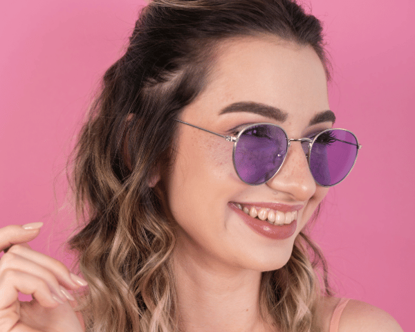young woman wearing purple tinted glasses